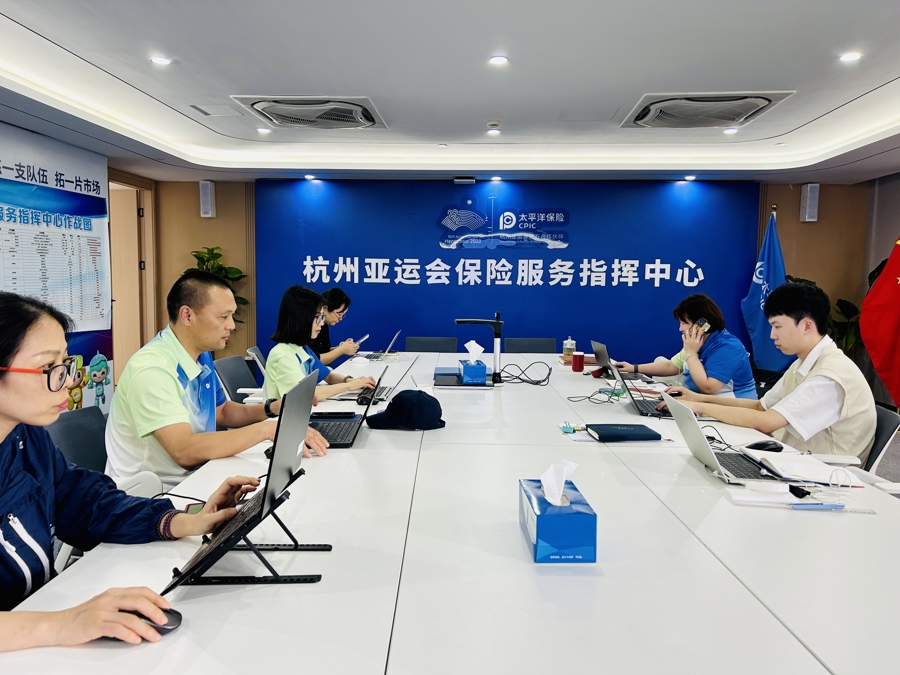 双节期间，丁国钢（左二）和同事们忙碌在保险指挥中心