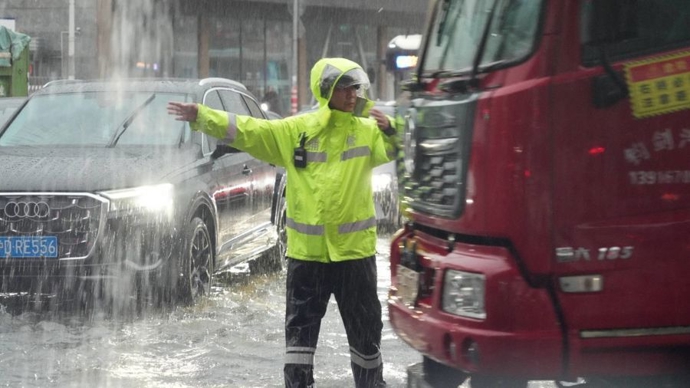 暴雨积水下，上海公安民警值守排涝救助受困群众